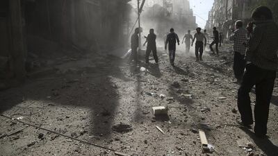 Residents of the town of Douma, eastern Ghouta of Damascus, inspect damage after an airstrike. Bassam Khabieh / Reuters