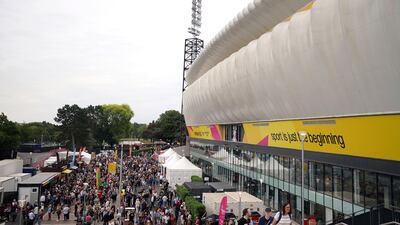 Spectators arrive before the opening ceremony at Alexander Stadium. AP