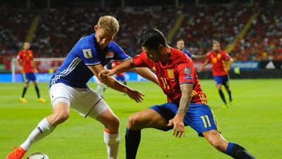Liechtenstein defender Martin Rechsteiner, left, vies with Spain midfielder Vitolo. Miguel Riopa / AFP