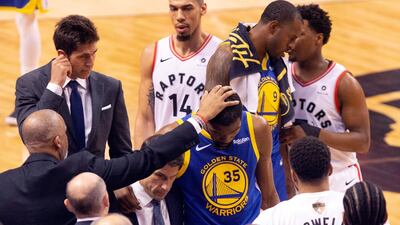 Golden State Warriors forward Kevin Durant is consoled as he walks off the court. AP Photo