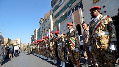 Security men stand during a funeral of the victims of the assault. Tasnim News Agency via Reuters
