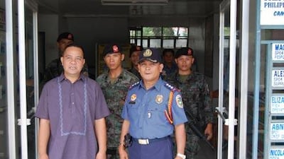 Father Leo Casas, left, and Eddie Benigay, Masbate's police director, have become prominent for their efforts to ensure peaceful elections in Masbate.