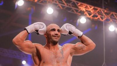 Mourad Bouzidi climbs the ropes to celebrate his win over Dustin Jacoby. Victor Besa / The National