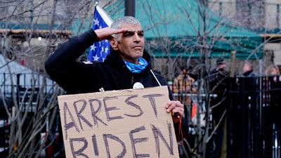 A supporter of Mr Trump outside the Manhattan District Attorney's office in New York. AFP