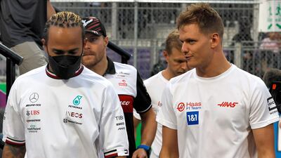 Lewis Hamilton chats Haas driver Mick Schumacher after the drivers' parade ahead of the 2022 Saudi Arabia Grand Prix. AFP