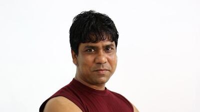 Anil Sonkar, a welder from Uttar Pradesh, India, has his portrait taken at Al Quoz Industrial Area in Dubai. Pawan Singh / The National