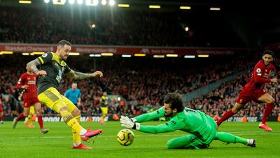 Southampton's Danny Ings, left, challenges Liverpool's goalkeeper Alisson Becker. EPA