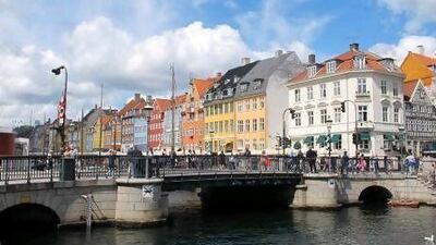 A bridge spans a canal to Nyhavn, a lovely enclave of 17th- and 18th-century buildings developed by King Christian V. All of Copenhagen is easily accessible by bicycle. Photo by Rosemary Behan