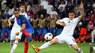 Dimitri Payet, left, curls in France's second goal on 96 minutes to guarantee France's progress to the knockout round of Euro 2016 with a game remaining in Group A. Oliver Weiken / EPA