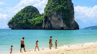 Tourists walk along Phra Nang beach in Krabi. Thailand has resumed quarantine-free travel for vaccinated tourists after the Test & Go programme was suspended owing to the fast-spreading Omicron Covid-19 variant. AFP