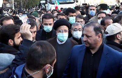 Iranian President Ebrahim Raisi, centre, at a funeral procession. AFP Photo