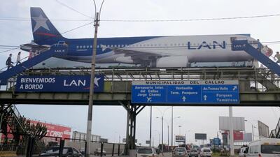 A billboard shows a LAN Airlines plane, a member of Latam Airlines, near the Jorge Chavez airport in Callao, Peru. Latam is bringing in a new passenger ticket pricing model. Mariana Bazo / Reuters