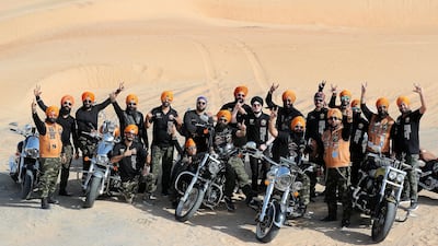 Nineteen members of Singhs Motorcycle Club UAE gather for a group photo. Pawan Singh / The National