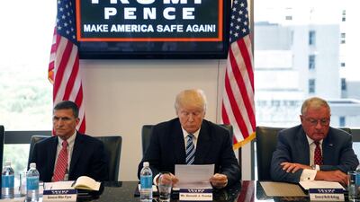 Donald Trump participates in a roundtable discussion on national security in his offices in Trump Tower in New York, with Gen Mike Flynn, left, and Lt Gen Keith Kellogg. Trump’s transition team is rich with lobbyists, a climate change denier and an ex-federal prosecutor involved in the mass firings of US lawyers. Gen Kellogg and Gen Flynn, both retired, have been advising Mr Trump on foreign policy and national security. Gerald Herbert / AP Photo