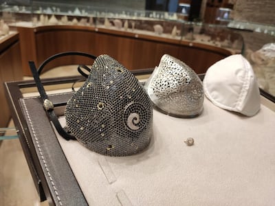 The face mask and its different layers. The outer, diamond cover layer; the filigree gold inner layer, and the removable N99 filter. Courtesy Yvel