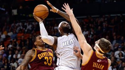 Miami's LeBron James looks for a way past Cleveland Cavaliers' Alonzo Gee and Tyler Zeller