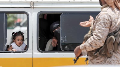A Yemeni soldier speaks to a woman riding in a bus in Mukalla. AFP