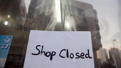 A ‘closed’ sign announces a shuttered convenience store in Abu Dhabi. Silvia Razgova / The National
