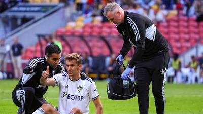 Leeds United's Diego Llorente receives medical treatment. AFP
