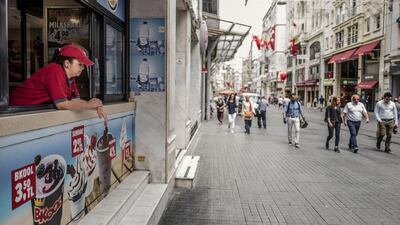 A vendor waits for customers on a half empty Taksim street in Istanbul. Ismail Ferdous / Bloomberg