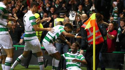 Moussa Dembele of Celtic celebrates with teammates after scoring his second goal against Manchester City. Michael Steele / Getty Images