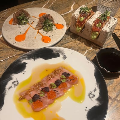 Salvaje's hamachi and truffle, wagyu beef gyozas and tuna tacos. Tom Evans / The National