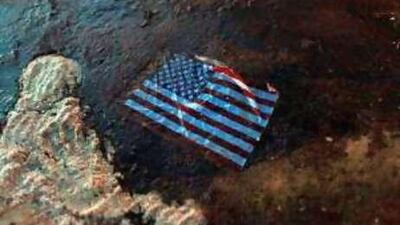 An American flag lies in an oil slick washed ashore from the Deepwater Horizon leak in the Gulf of Mexico.