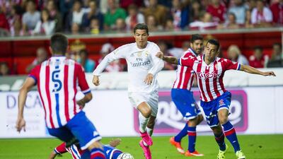 Cristiano Ronaldo of Real Madrid duels for the ball with Luis Hernandez of Real Sporting de Gijon during the La Liga match between Sporting Gijon and Real Madrid at Estadio El Molinon on August 23, 2015 in Gijon, Spain. (Photo by Juan Manuel Serrano Arce/Getty Images)