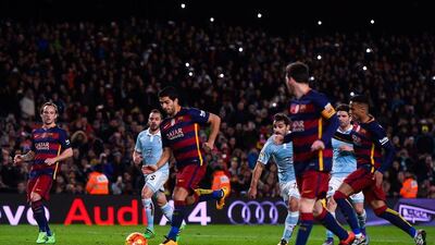 Luis Suarez of FC Barcelona celebrates with his teammate Lionel Messi of FC Barcelona after scoring his team’s fourth goal from the penalty spot during the La Liga match between FC Barcelona and Celta Vigo at Camp Nou on February 14, 2016 in Barcelona, Spain. Messi took the penalty, tapping the ball softly forward for Suarez to score. (Photo by David Ramos/Getty Images)