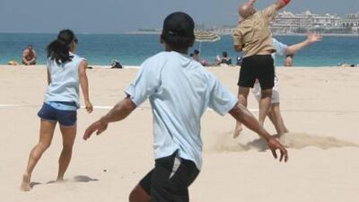 Players vie for a frisbee during the beach frisbee tournament at Jumeirah Beach Residence in Dubai.