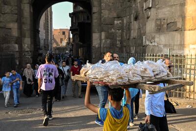 A bakery in the old quarter of Cairo takes a delivery of fresh bread. Egypt's leaders are concerned about the effect on the economy from the Iran-Israel war. AFP