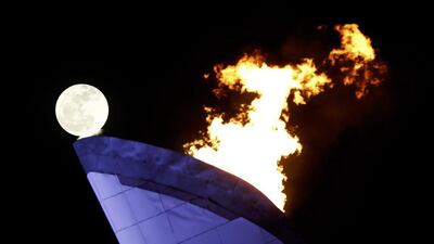 The moon rises behind the cauldron at the Olympic Park on Saturday. Gary Hershorn / Reuters