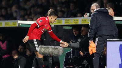 Alexis Sanchez shakes hands with Jose Mourinho after his debut for Manchester United in the FA Cup on Friday. Paul Childs / Reuters