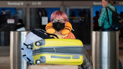 Emirates has advised travellers to wear face masks and gloves and observe social distancing when flying. AFP