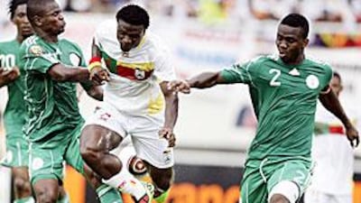 Benin's Razak Omotoyossi, centre, with Nigeria's Uwa Echiejile, left, and Joseph Yobo.