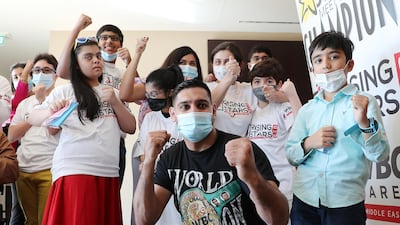 Boxing champion Amir Khan meets members of the Rising Stars initiative at the Fairmont The Palm hotel in Dubai. Pawan Singh / The National