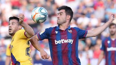 Barcelona's Carles Perez, left, clashes with Levante's Sergio Postigo in Valencia on Saturday. AP