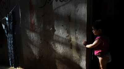 A Syrian child from the city of Dara'a stands in the doorway of the home she shares with extended members of her family in a poor neighborhood with a high concentration of Syrian refugees in Beirut, Lebanon. Spencer Platt / Getty Images