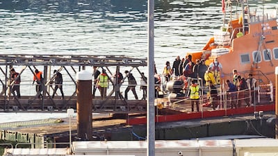 A lifeboat brings a group of migrants to the Port of Dover in south-east England. Getty Images