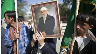 Supporters of Burhanuddin Rabbani gather outside his house in Kabul yesterday. Ahmad Masood / Reuters