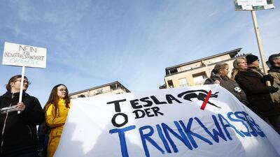 Protesters hold a banner reading 'Tesla or drinking water' as they demonstrate against the proposed Tesla Gigafactory on the main square in Gruenheide, Germany. Getty Images