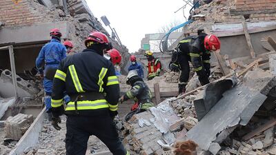 Emergency workers in the rubble of a civilian building after an air strike in Rzhyshchiv, Ukraine. Reuters