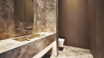 The abundance of marble is complemented by other premium materials including travertine stone, oak and iroko wood, bronze and lacquered black glass. Courtesy LuxuryProperty.com