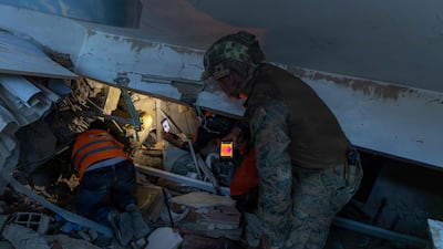 A US Marine and local people carry out a search-and-rescue operation in La Guaira. AFP