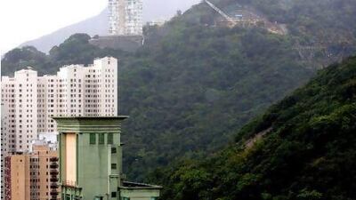 Construction work takes place on 53 Stubbs Road, top right, designed by Frank Gehry, in Hong Kong. Bloomberg News