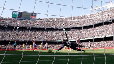 Barcelona's Ferran Torres shoots past Atletico Madrid goalkeeper Jan Oblak at Camp Nou. Reuters