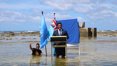 Simon Kofe, Foreign Minister of island nation Tuvalu, gives his Cop26 speech while showing the effect of rising sea levels. Reuters