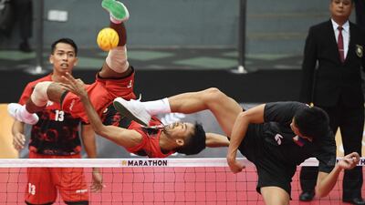 Indonesia's Syaiful Rijal competes with Regie Reznan Fabriga of the Philippines (R) during their men's team doubles preliminary round robin sepak takraw match at the 29th Southeast Asian Games (SEA Games) in Kuala Lumpur. Adek Berry / AFP