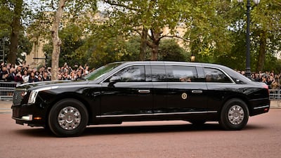 Mr Biden in his presidential car 'The Beast' as it drives to Buckingham Palace on Sunday. AFP