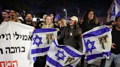 People gather to watch the military helicopter carrying three Israeli female hostages land at Sheba Medical Center in Ramat Gan, Israel. EPA